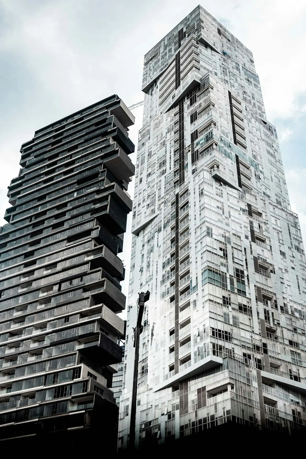 low angle photography of twp black and white high rise buildings